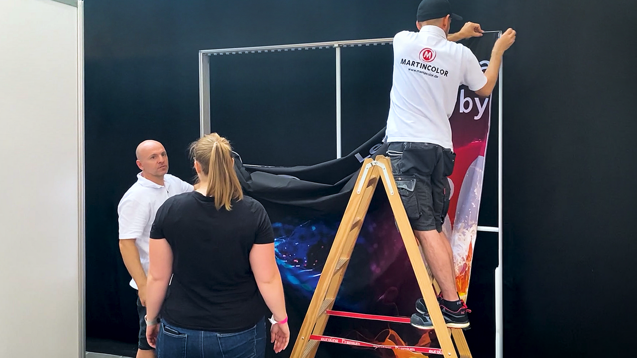 Exhibition stand assembly training - installing textile graphics